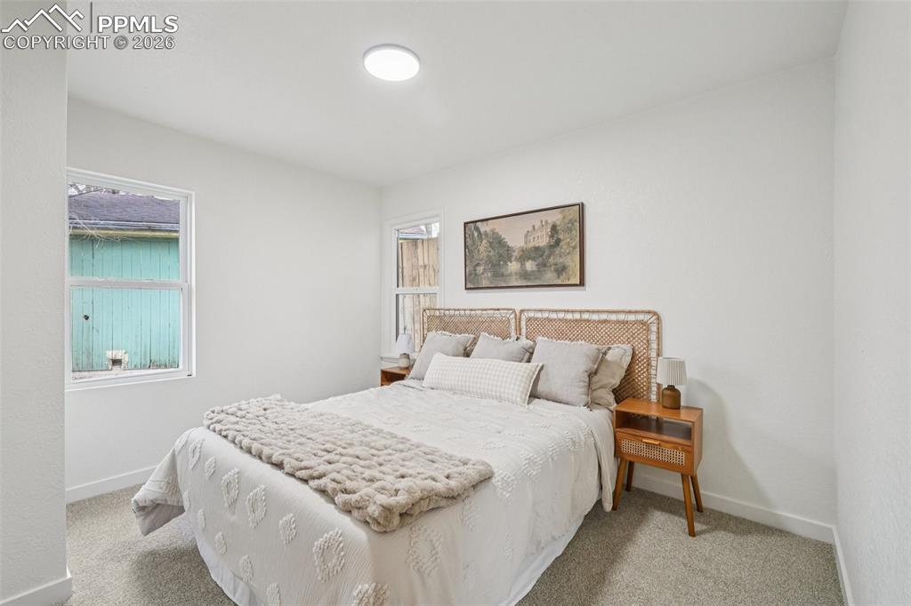 740 East Rio Grande Street Colorado Springs, CO 80903 - Photo 17 of 25 a bedroom with a bed and a painting on the wall