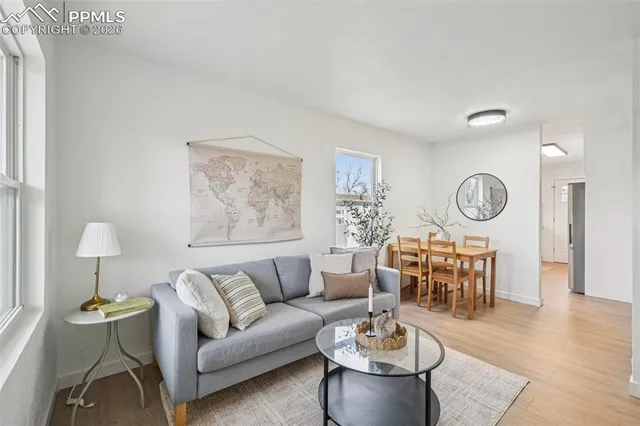 a living room with furniture a clock and a window