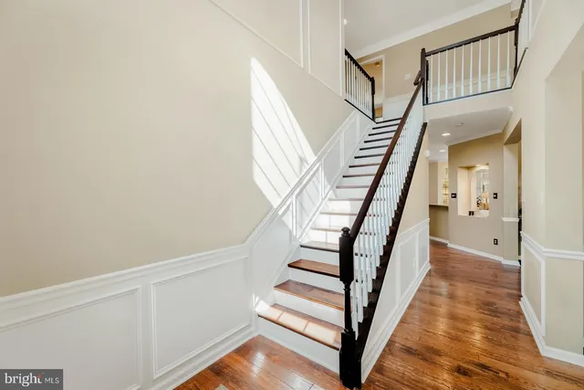 a view of entryway with wooden floor and stairs