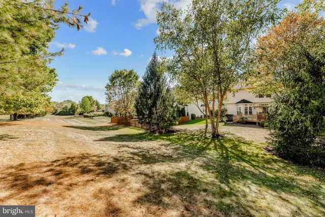a yellow house with trees in front of it