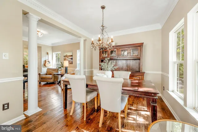 a view of a dining room with furniture wooden floor and chandelier