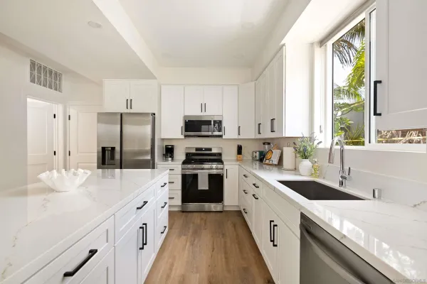 a bathroom with a granite countertop toilet sink and mirror
