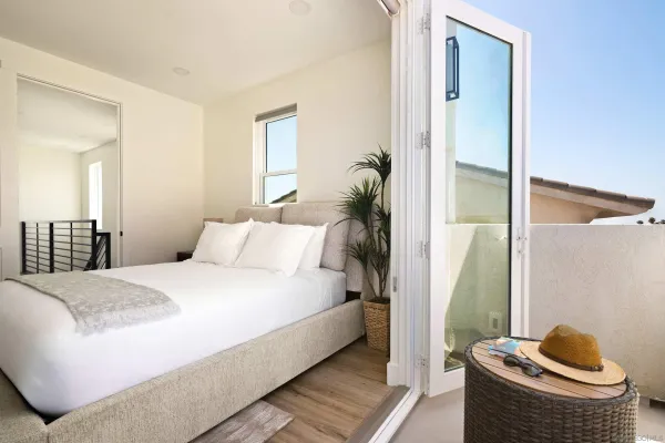 a bedroom with a bed and a mirror