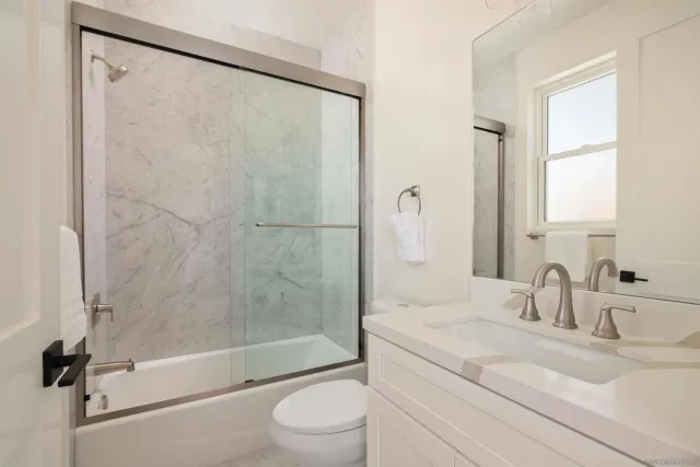 a bedroom with a bed and a mirror