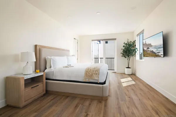 a bedroom with a bed and a flat screen tv