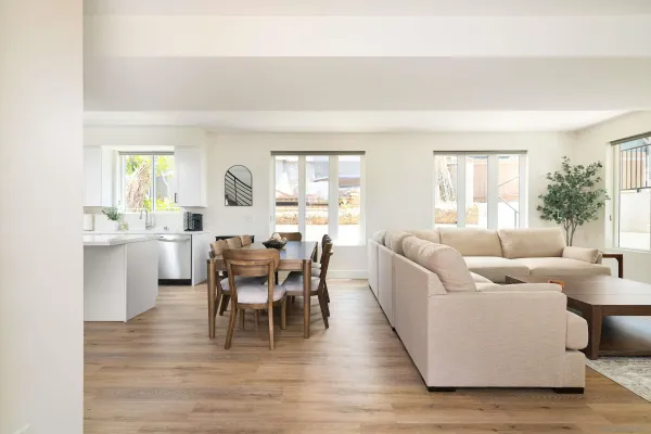 a living room with furniture wooden floor and a large window