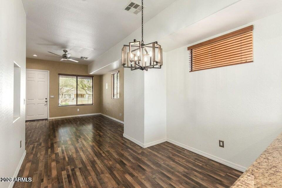 9551 East Redfield Road, Unit 1008 Scottsdale, AZ 85260 - Photo 12 of 19 a view of empty room with wooden floor and fan