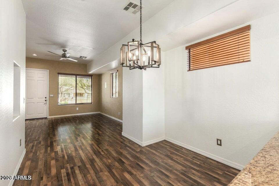 9551 East Redfield Road, Unit 1008 Scottsdale, AZ 85260 - Photo 12 of 19 a view of empty room with wooden floor and fan