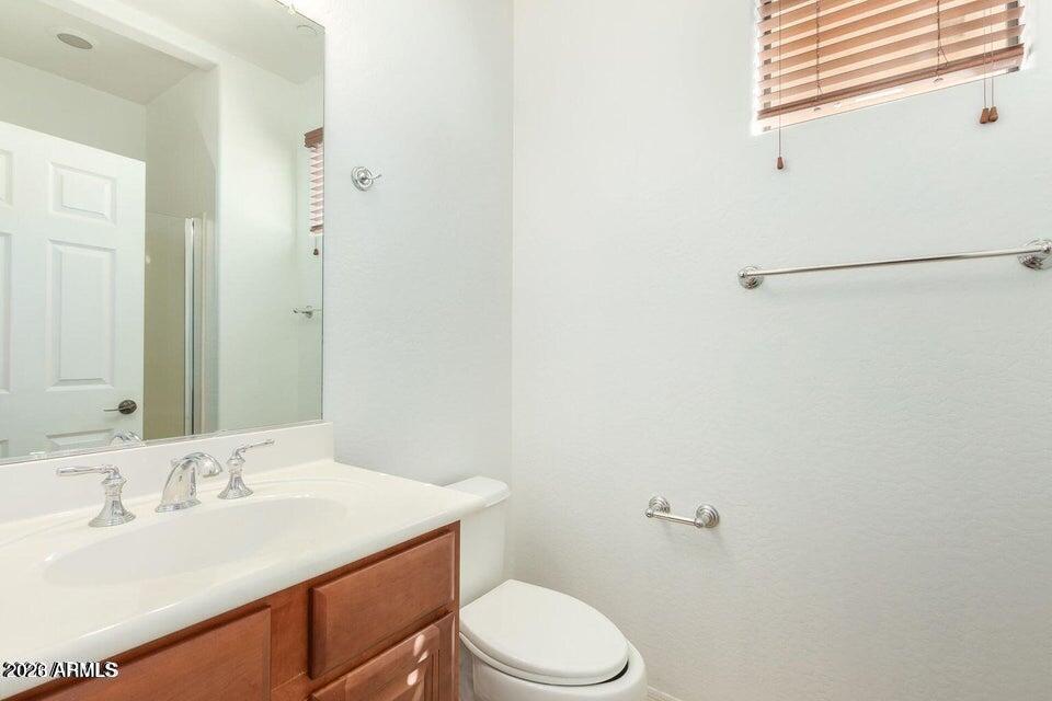 9551 East Redfield Road, Unit 1008 Scottsdale, AZ 85260 - Photo 14 of 19 a bathroom with a sink vanity mirror and toilet