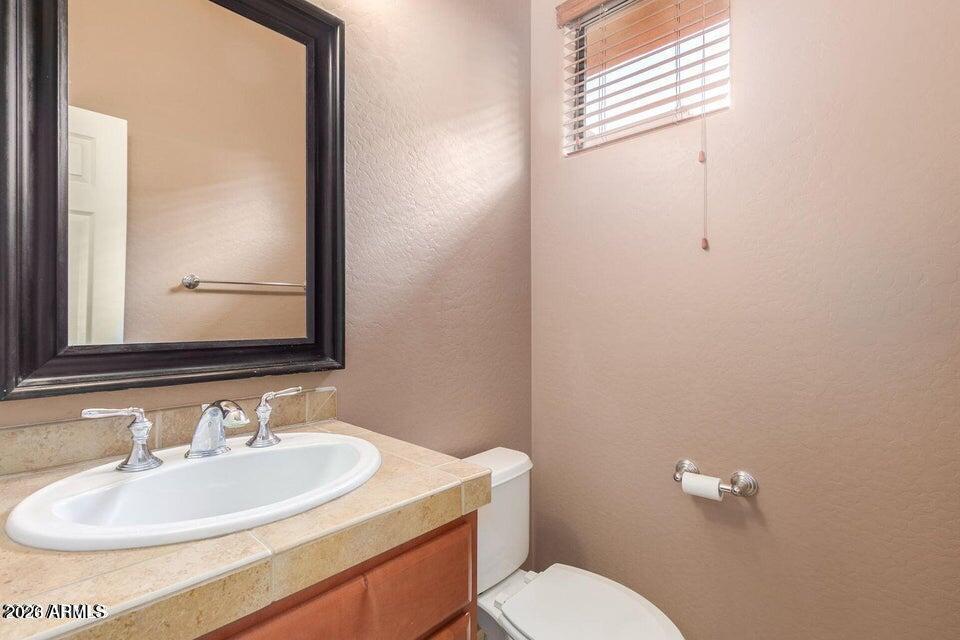 9551 East Redfield Road, Unit 1008 Scottsdale, AZ 85260 - Photo 18 of 19 a bathroom with a sink and a toilet