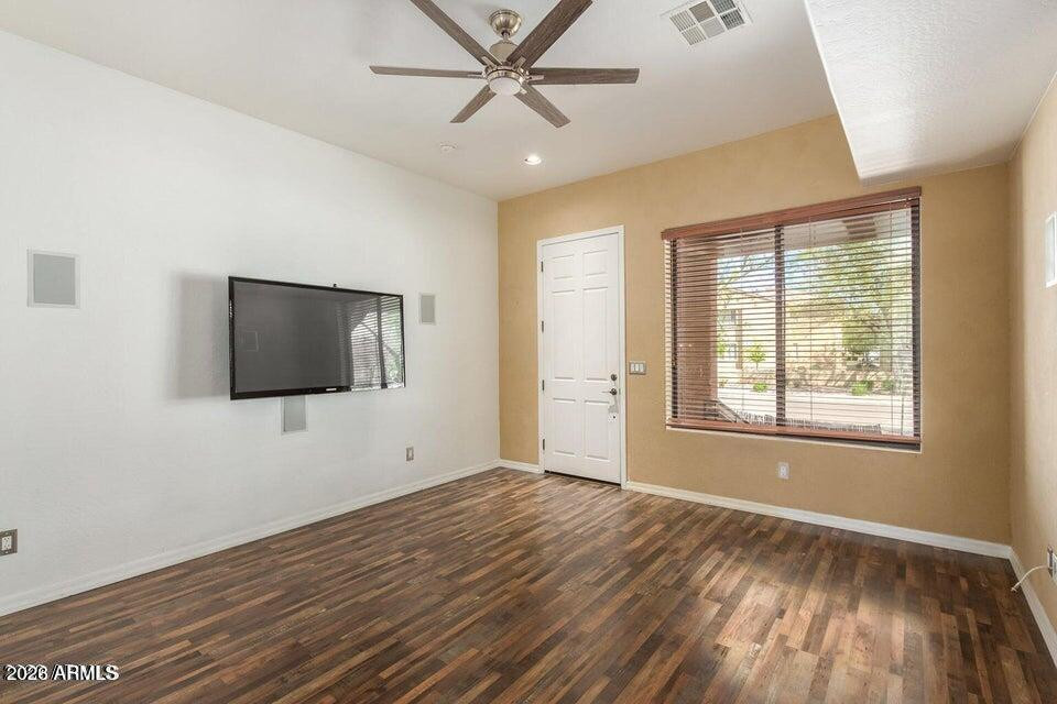 9551 East Redfield Road, Unit 1008 Scottsdale, AZ 85260 - Photo 6 of 19 a view of an empty room with wooden floor and a window