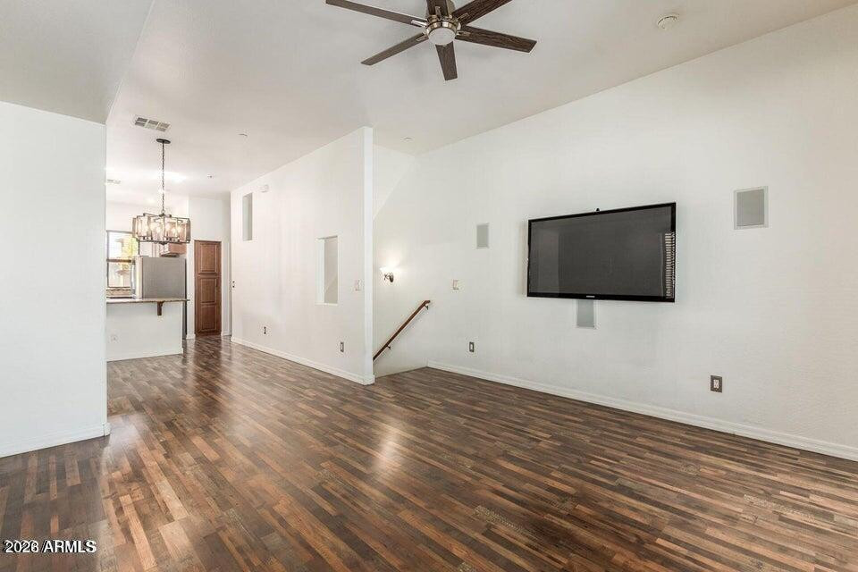 9551 East Redfield Road, Unit 1008 Scottsdale, AZ 85260 - Photo 7 of 19 a view of empty room with wooden floor and fan