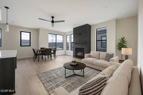 a living room with furniture a fireplace and a table