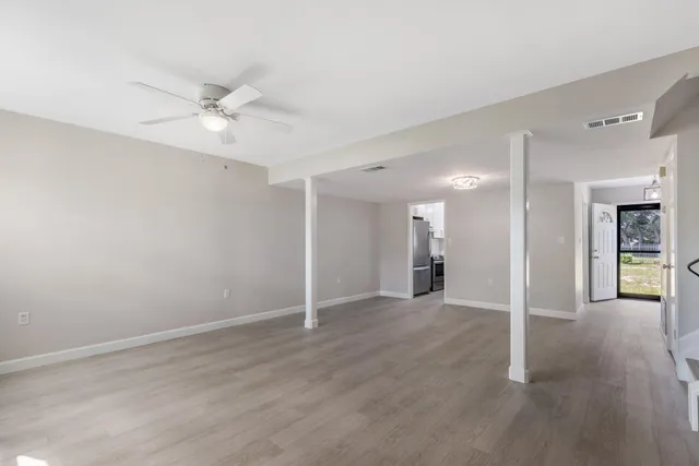 a kitchen with granite countertop a sink stainless steel appliances cabinets and a window