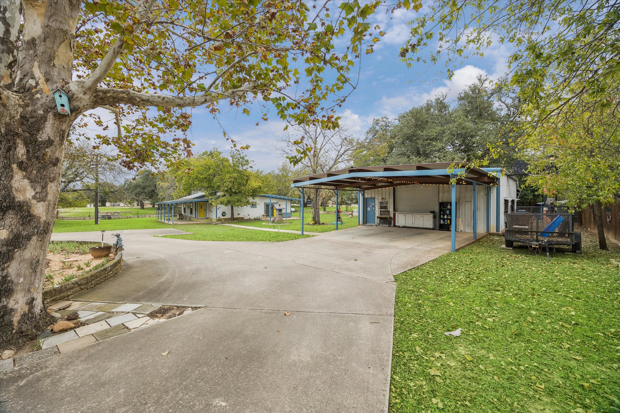 3502 1869th Ranch Liberty Hill, TX 78642 - Photo 1 of 20 View of front of house with a front yard, an outbuilding, and driveway