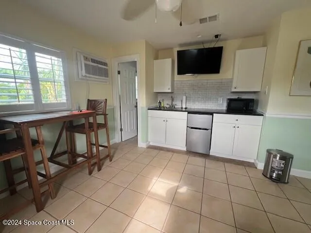 a kitchen with stainless steel appliances a stove a sink a microwave and a refrigerator
