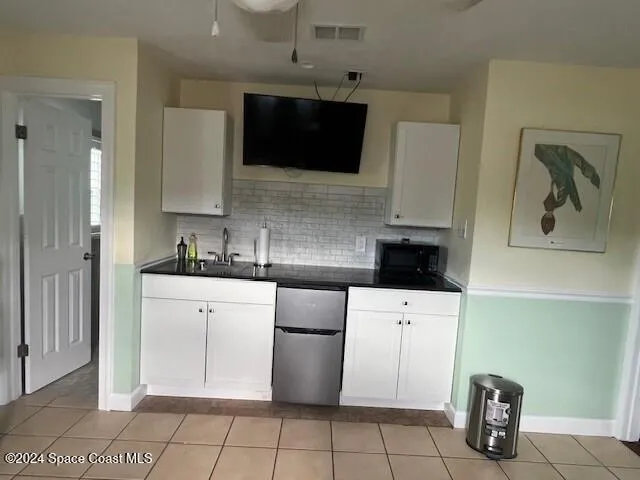 a kitchen with a sink a stove and cabinets