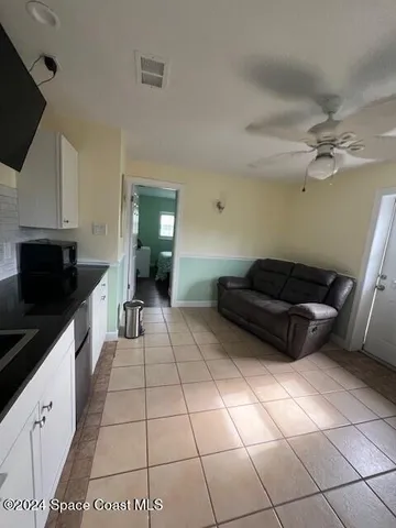a kitchen with a sink a stove and cabinets