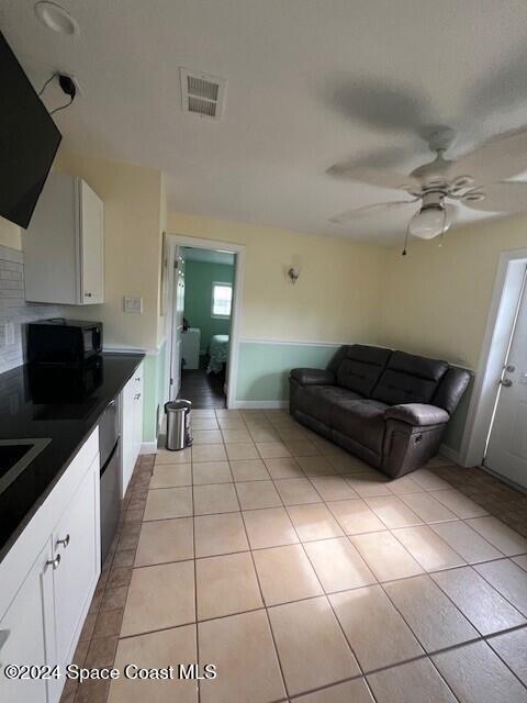 303 Amherst Avenue Melbourne, FL 32901 - Photo 4 of 7 a kitchen with a sink a stove and cabinets