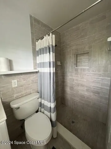 a white toilet sitting next to a bathroom sink