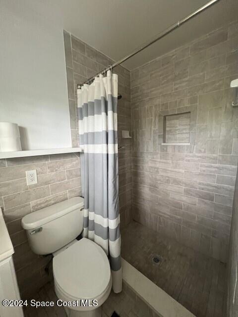 303 Amherst Avenue Melbourne, FL 32901 - Photo 6 of 7 a white toilet sitting next to a bathroom sink