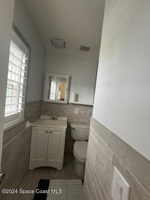 303 Amherst Avenue Melbourne, FL 32901 - Photo 7 of 7 a bathroom with a sink a toilet and window