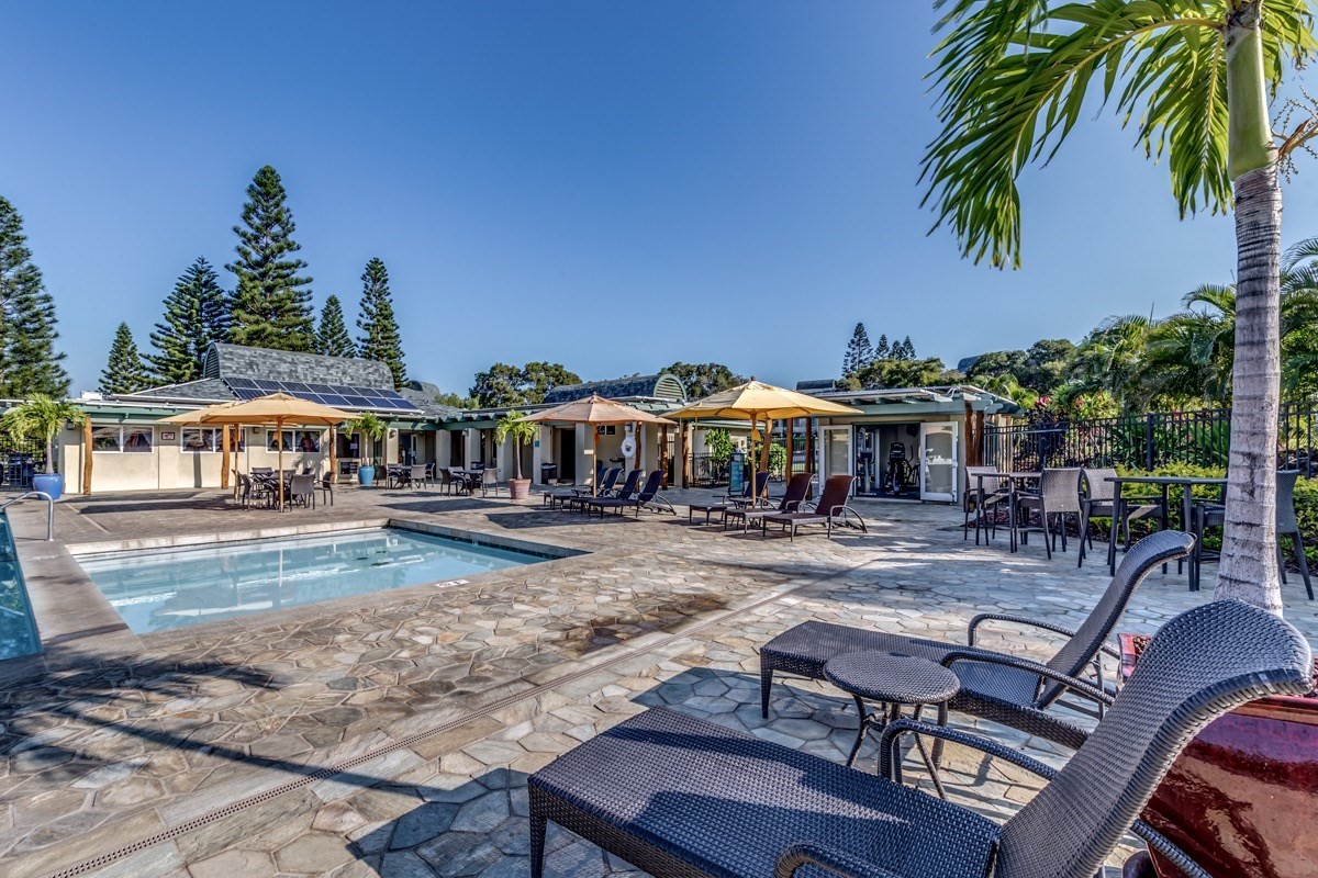 68-1745 Waikoloa Road, Unit L101 Waikoloa, HI 96738 - Photo 18 of 27 a view of a swimming pool with lawn chairs under an umbrella