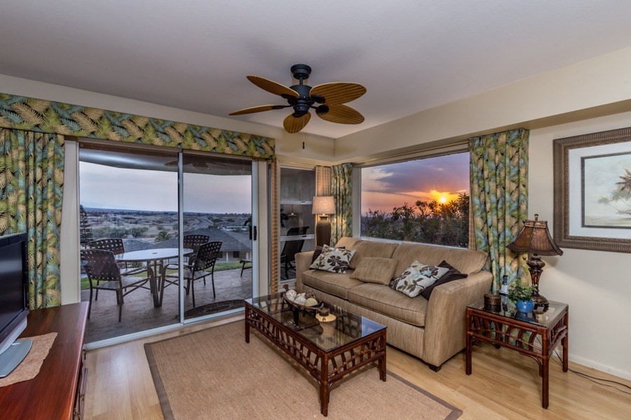 68-1745 Waikoloa Road, Unit L101 Waikoloa, HI 96738 - Photo 2 of 27 a living room with furniture a chandelier and a floor to ceiling window