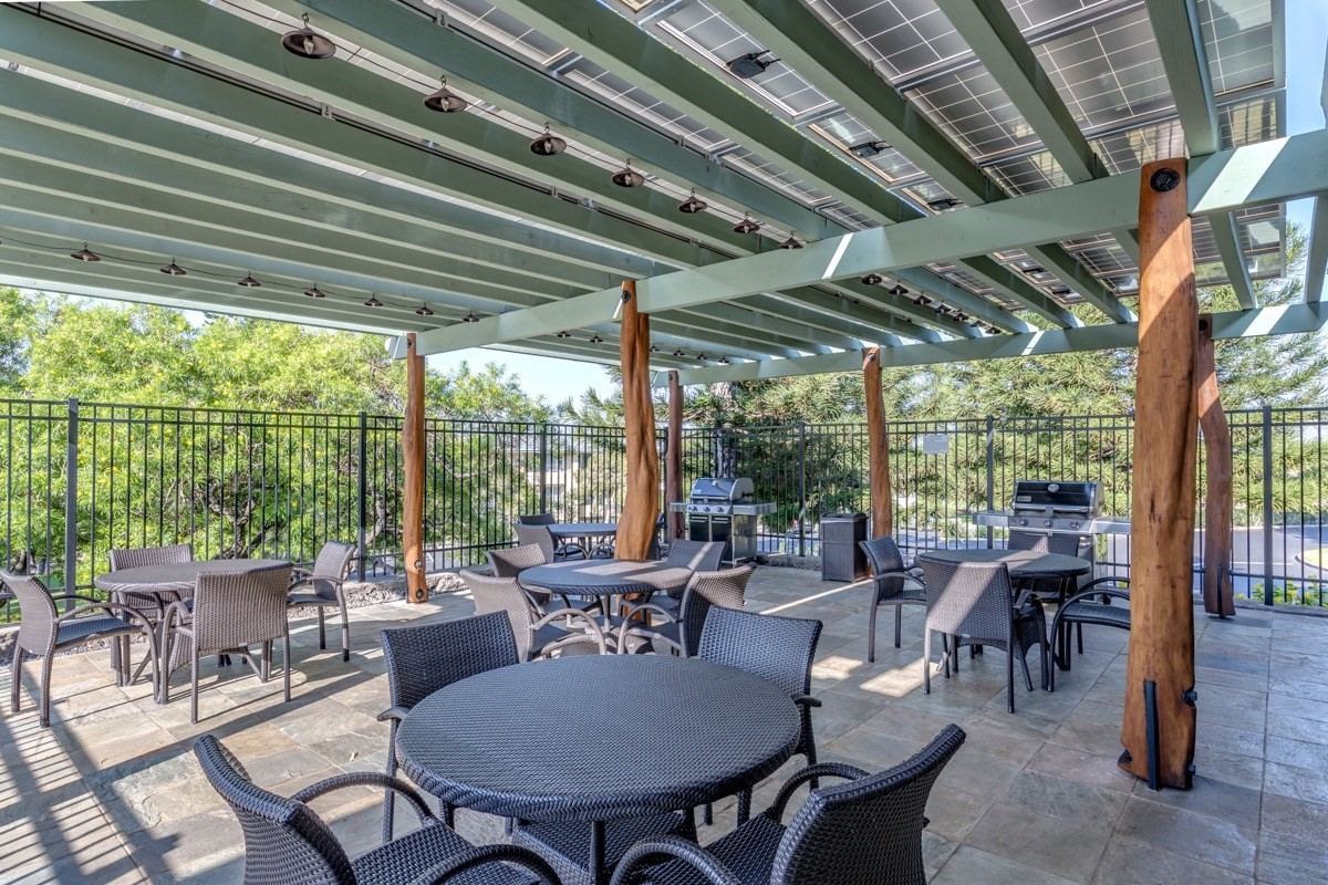 68-1745 Waikoloa Road, Unit L101 Waikoloa, HI 96738 - Photo 22 of 27 a view of a patio with table and chairs and potted plants