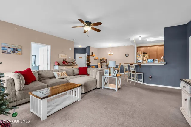 a living room with furniture and a chandelier