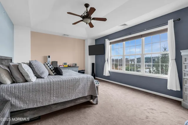 a bedroom with a bed couch and window