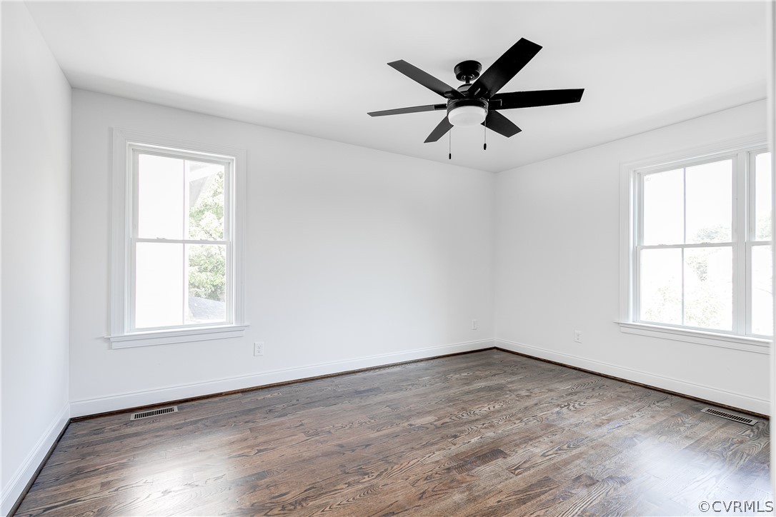 2405 Everett Street Richmond, VA 23224 - Photo 23 of 24 an empty room with wooden floor a ceiling fan and windows