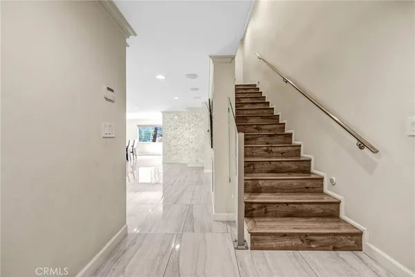 a view of entryway and hall with wooden floor