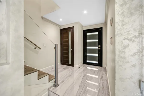 a view of a hallway with wooden floor and entryway