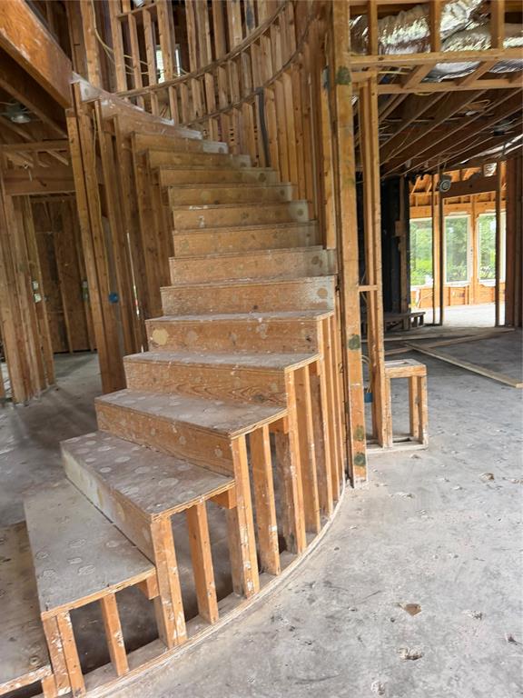 83 Bass Road Pottsboro, TX 75076 - Photo 25 of 31 Curved staircase framing with open risers and plywood treads