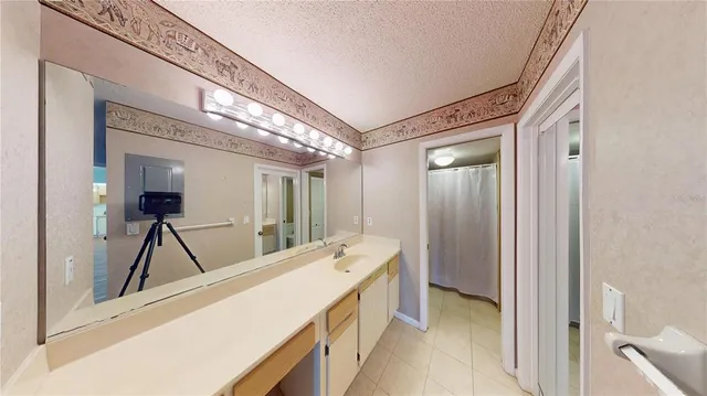 a spacious bathroom with a sink and mirror