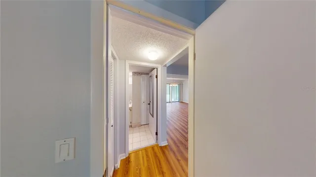 a view of a hallway with wooden floor