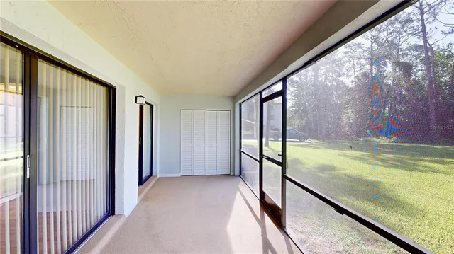 a view of a room with wooden floor and a balcony
