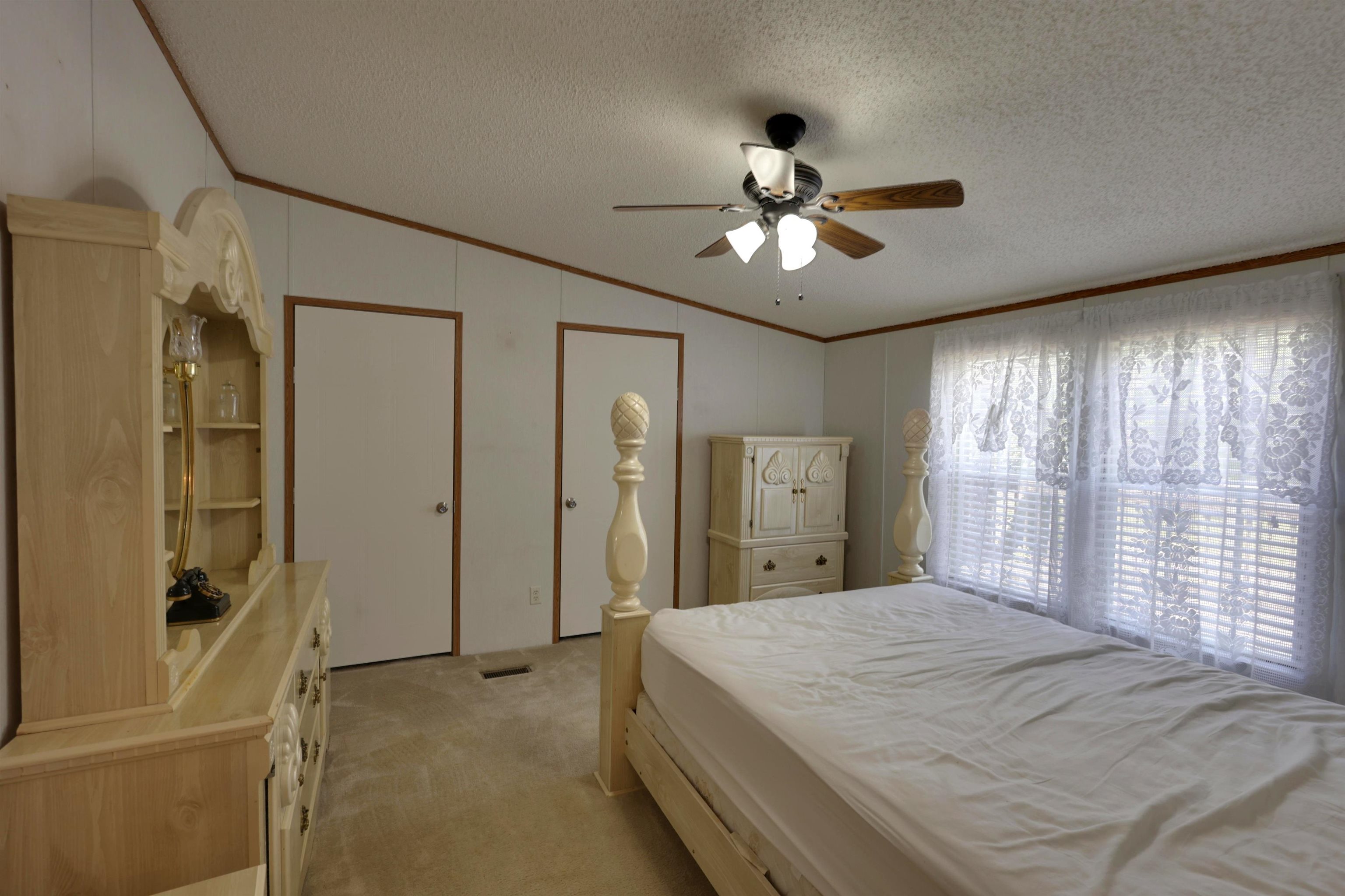 39 Cr 360 Road Iuka, MS 38852 - Photo 24 of 31 a spacious bedroom with a large bed a chandelier and a large window