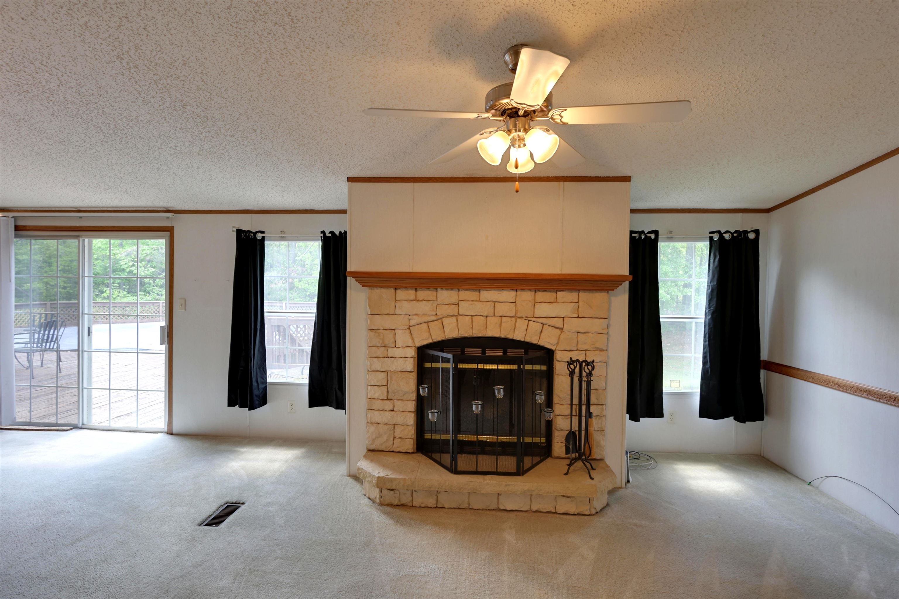39 Cr 360 Road Iuka, MS 38852 - Photo 5 of 31 a living room with furniture and a fireplace