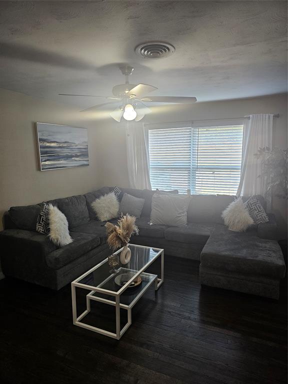 9911 Ferguson Road Dallas, TX 75228 - Photo 2 of 18 Living area featuring dark wood-style flooring and a ceiling fan