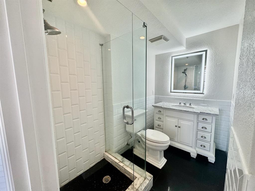 13 Royal Palm Way, Unit 5050 Boca Raton, FL 33432 - Photo 18 of 31 a bathroom with a granite countertop toilet and a shower