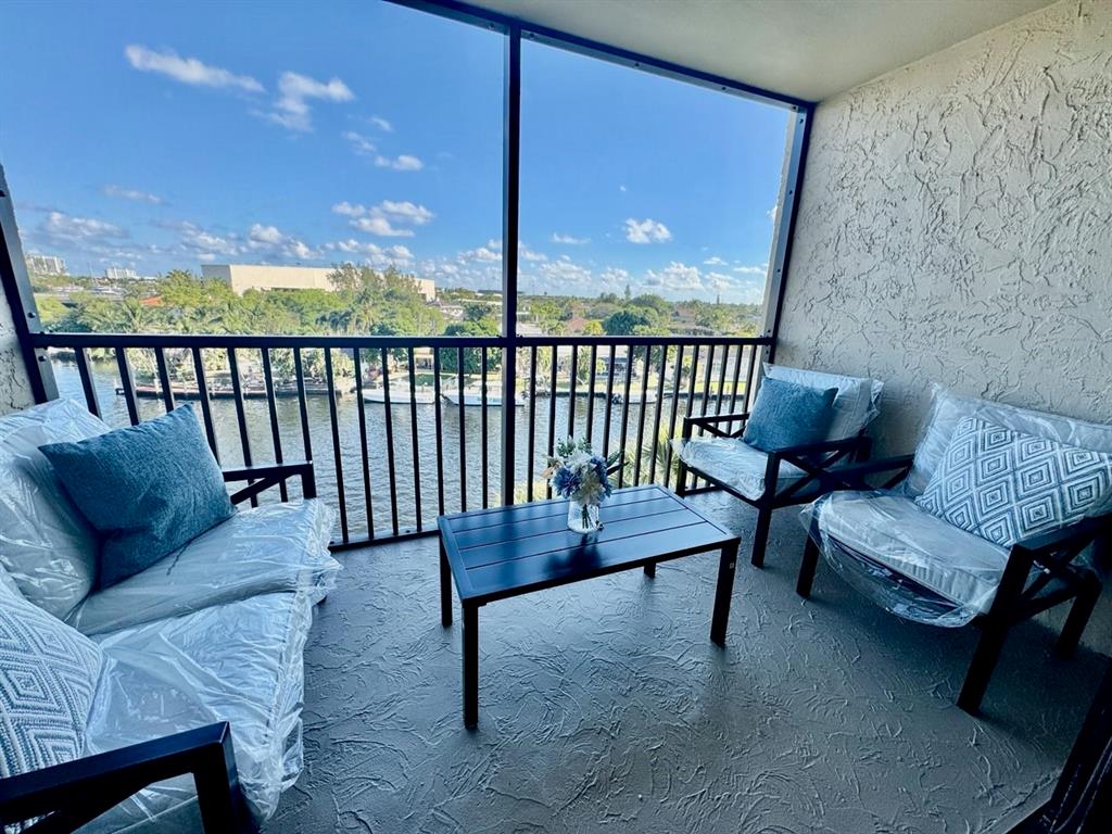 13 Royal Palm Way, Unit 5050 Boca Raton, FL 33432 - Photo 2 of 31 a balcony with furniture and wooden floor