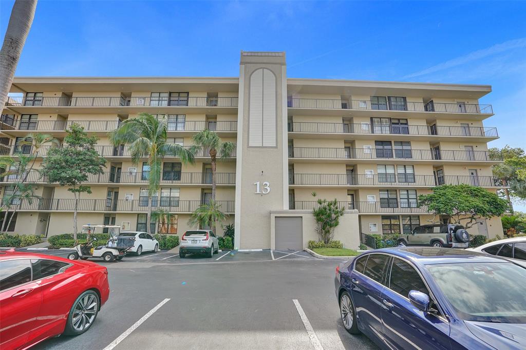 13 Royal Palm Way, Unit 5050 Boca Raton, FL 33432 - Photo 26 of 31 a front view of a building with lot of cars parked