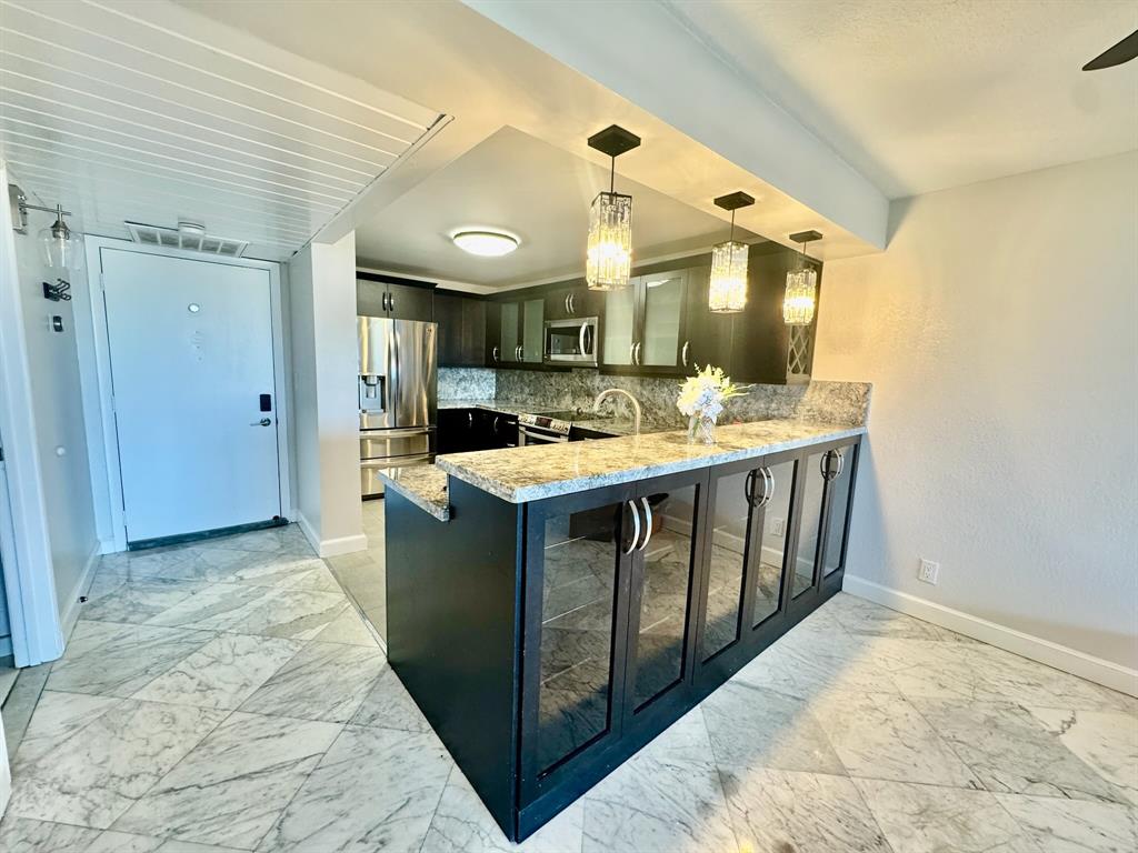 13 Royal Palm Way, Unit 5050 Boca Raton, FL 33432 - Photo 7 of 31 a kitchen with stainless steel appliances granite countertop a stove and a sink