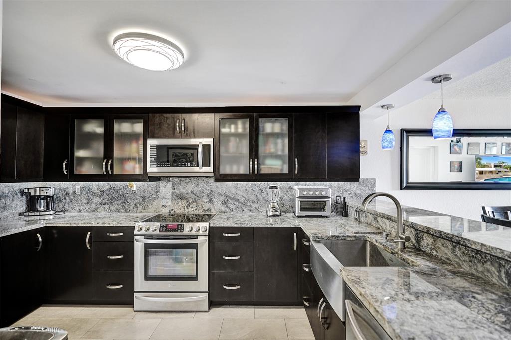 13 Royal Palm Way, Unit 5050 Boca Raton, FL 33432 - Photo 8 of 31 a kitchen with a stove and a sink