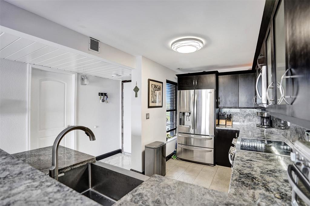 13 Royal Palm Way, Unit 5050 Boca Raton, FL 33432 - Photo 10 of 31 a kitchen with stainless steel appliances granite countertop a refrigerator sink and stove