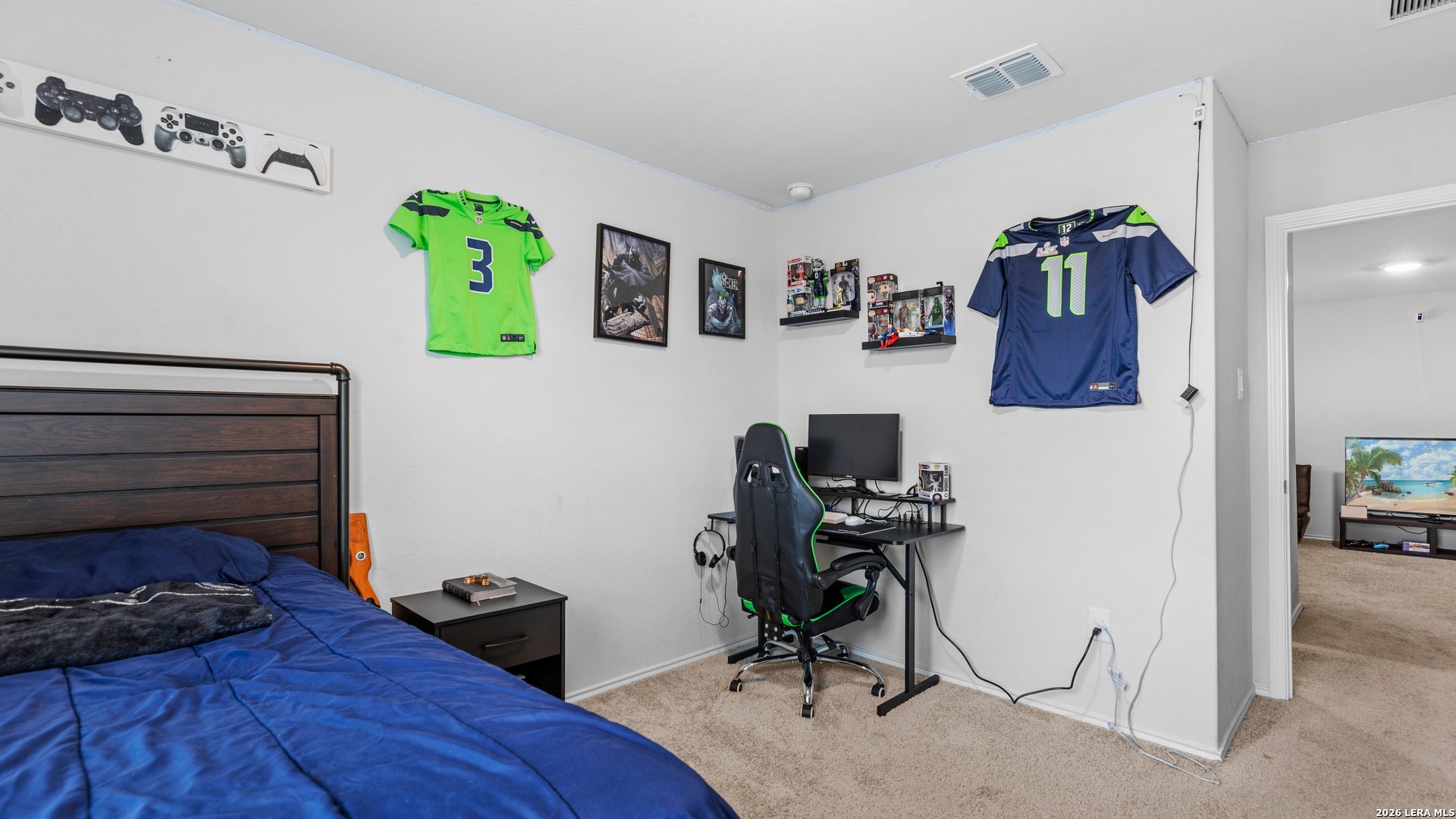 731 Monarch Drive Seguin, TX 78155 - Photo 16 of 21 a bedroom with a bed and a desk
