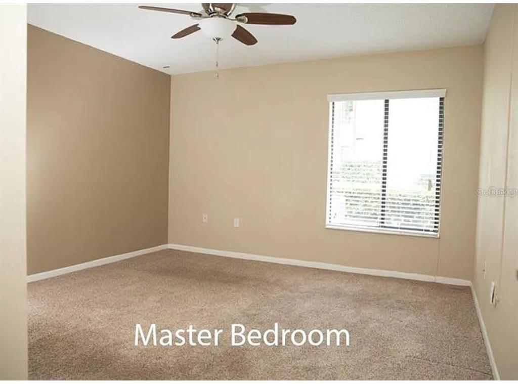 1724 Pine Ridge Way West, Unit B1 Palm Harbor, FL 34684 - Photo 11 of 12 a view of an empty room with a window