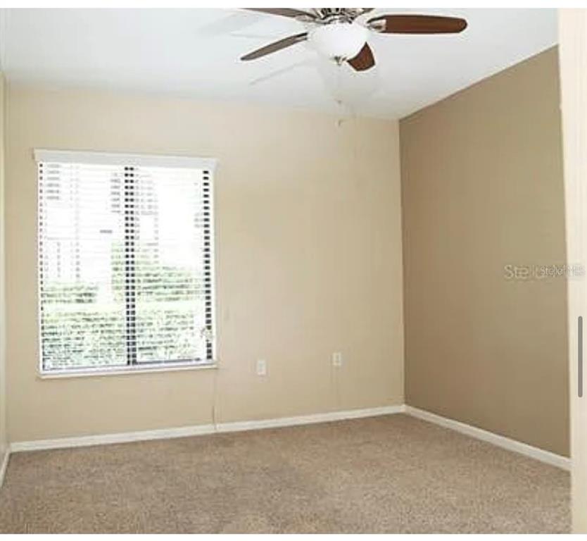 1724 Pine Ridge Way West, Unit B1 Palm Harbor, FL 34684 - Photo 5 of 12 a view of an empty room with windows